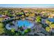Aerial view of a sparkling community pool surrounded by palm trees, offering a resort-like atmosphere at 10237 Andante Ct, Las Vegas, NV 89135