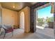 Cozy front porch with stone detailing, offering a glimpse of the neighborhood and outdoor seating at 10237 Andante Ct, Las Vegas, NV 89135