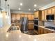 Modern kitchen with stainless steel appliances, breakfast bar, and sleek cabinets at 10237 Andante Ct, Las Vegas, NV 89135