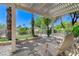 Backyard pergola with seating area overlooking mature landscaping at 10237 Andante Ct, Las Vegas, NV 89135