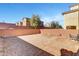 Expansive backyard with gravel, block wall, and patio set ideal for outdoor entertaining at 10735 Galveston Bay St, Las Vegas, NV 89179