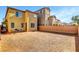 Spacious backyard with gravel, a block wall, and a patio set for outdoor relaxation at 10735 Galveston Bay St, Las Vegas, NV 89179