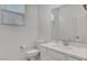 Neat bathroom with a sink, toilet and a vanity mirror providing essential amenities at 10735 Galveston Bay St, Las Vegas, NV 89179