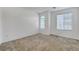 Bright bedroom featuring neutral walls, carpet, and windows providing natural light at 10735 Galveston Bay St, Las Vegas, NV 89179