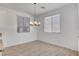 Bright dining area with chandelier lighting and large windows, perfect for Gathering meals at 10735 Galveston Bay St, Las Vegas, NV 89179