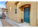 Close-up of front entry with teal door, decorative accents, and gravel lined walkway at 10735 Galveston Bay St, Las Vegas, NV 89179