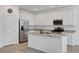 Bright kitchen features stainless steel appliances, white cabinets, granite countertops, and a spacious center island at 10735 Galveston Bay St, Las Vegas, NV 89179