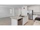 Open kitchen featuring stainless appliances, granite counters and a spacious island at 10735 Galveston Bay St, Las Vegas, NV 89179