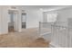 Upstairs landing features neutral carpet and offers seamless access to multiple bedrooms through white doors at 10735 Galveston Bay St, Las Vegas, NV 89179