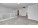 Upstairs landing with plush neutral carpeting offers views of a laundry area and a well-lit bathroom at 10735 Galveston Bay St, Las Vegas, NV 89179