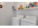 Bright laundry room with washer, dryer, and shelving for storage at 10735 Galveston Bay St, Las Vegas, NV 89179