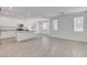 Open-concept living area and kitchen with ample natural light and stylish flooring at 10735 Galveston Bay St, Las Vegas, NV 89179