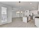 Open-concept area boasts a modern kitchen, dining space, and access to outdoor patio at 10735 Galveston Bay St, Las Vegas, NV 89179