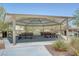 Covered picnic area featuring multiple picnic tables and trash receptacles for community gatherings at 10735 Galveston Bay St, Las Vegas, NV 89179