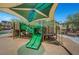 Playground with slides, ladders, and a covered seating area at 10735 Galveston Bay St, Las Vegas, NV 89179
