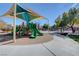 Community playground featuring slides, climbing structures, and a shaded canopy at 10735 Galveston Bay St, Las Vegas, NV 89179