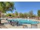 Community pool surrounded by chairs and tables at 10735 Galveston Bay St, Las Vegas, NV 89179