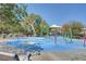 Community splash pad area with colorful play structures and seating for families at 10735 Galveston Bay St, Las Vegas, NV 89179