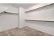 Walk-in closet with carpet and wooden shelf supports, ready to organize your wardrobe at 10735 Galveston Bay St, Las Vegas, NV 89179