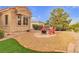 Cozy backyard featuring a fire pit, red chairs, and low-maintenance landscaping at 10801 Clarion Ln, Las Vegas, NV 89134