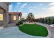 Landscaped backyard featuring a fire pit, artificial turf, and ample seating, perfect for outdoor relaxation and entertaining at 10801 Clarion Ln, Las Vegas, NV 89134
