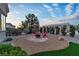 Backyard featuring a fire pit, ample seating, and manicured landscaping, perfect for enjoying outdoor living at 10801 Clarion Ln, Las Vegas, NV 89134
