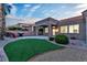 Charming backyard with artificial turf, desert landscaping, and covered patio perfect for outdoor entertaining at 10801 Clarion Ln, Las Vegas, NV 89134