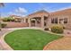 Lush backyard features manicured landscaping, stone accents, and patio area at 10801 Clarion Ln, Las Vegas, NV 89134