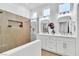 Modern bathroom with double sinks, a walk-in shower, and bright lighting at 10801 Clarion Ln, Las Vegas, NV 89134