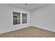 Cozy bedroom with wood-look flooring and abundant natural light from two windows at 10801 Clarion Ln, Las Vegas, NV 89134