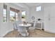 A modern dining area featuring a round table, stylish chairs, and ample natural light at 10801 Clarion Ln, Las Vegas, NV 89134