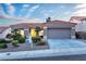 Attractive single-story home with a two-car garage and desert landscaping at 10801 Clarion Ln, Las Vegas, NV 89134