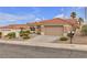 Charming home featuring a two-car garage, tile roof, and mature desert landscaping at 10801 Clarion Ln, Las Vegas, NV 89134