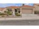 Charming single-story home with a tile roof, desert landscaping, and a two-car garage at 10801 Clarion Ln, Las Vegas, NV 89134