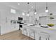 Modern kitchen with white cabinets, stainless steel appliances, and stylish pendant lighting at 10801 Clarion Ln, Las Vegas, NV 89134