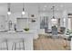 Modern eat-in kitchen featuring sleek white cabinetry, stainless appliances, and stylish pendant lights at 10801 Clarion Ln, Las Vegas, NV 89134