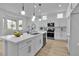 Bright kitchen featuring white cabinets, quartz countertops, stainless steel appliances, and breakfast nook at 10801 Clarion Ln, Las Vegas, NV 89134