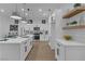 Modern kitchen features white cabinetry, stainless steel appliances and pendant lighting at 10801 Clarion Ln, Las Vegas, NV 89134