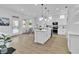 A modern eat-in kitchen with white cabinetry, an island, and stainless steel appliances at 10801 Clarion Ln, Las Vegas, NV 89134