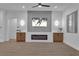 Modern living room with an electric fireplace, mounted TV, wood-look floors, and soft, neutral lighting at 10801 Clarion Ln, Las Vegas, NV 89134