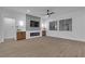 Cozy living room featuring a fireplace, TV, and ample natural light at 10801 Clarion Ln, Las Vegas, NV 89134