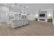 Open floor plan with kitchen island, living room and fireplace at 10801 Clarion Ln, Las Vegas, NV 89134
