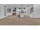 Open-concept living space with wood flooring and modern kitchen at 10801 Clarion Ln, Las Vegas, NV 89134