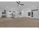 Spacious open-concept living area with kitchen, wood floors, modern lighting, and bright ambiance at 10801 Clarion Ln, Las Vegas, NV 89134