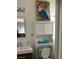 Cozy bathroom with stylish toucan painting and storage unit at 111 E Van Wagenen St, Henderson, NV 89015
