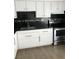Updated kitchen featuring modern white cabinetry, stainless steel appliances, and stylish backsplash at 111 E Van Wagenen St, Henderson, NV 89015