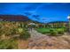 Lush backyard with a paved patio, manicured lawn, and mature landscaping, perfect for outdoor entertaining at 11238 Rebel Dome Ct, Las Vegas, NV 89141
