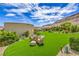 Relaxing backyard seating area with manicured lawn and lush landscaping, perfect for leisure at 11238 Rebel Dome Ct, Las Vegas, NV 89141