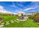 Expansive backyard featuring manicured lawn, covered patio, and outdoor dining area for entertaining at 11238 Rebel Dome Ct, Las Vegas, NV 89141