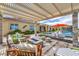 Spacious backyard with a pool, fire pit, and comfortable lounge seating at 11238 Rebel Dome Ct, Las Vegas, NV 89141
